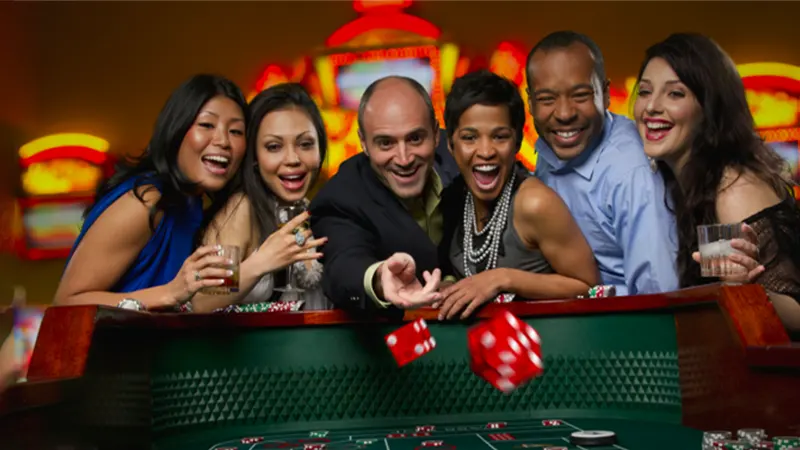 Group of people having fun at casino table with small bets treating gambling as entertainment