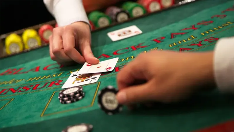 Classic single-deck blackjack table setup with minimal cards and traditional casino chips