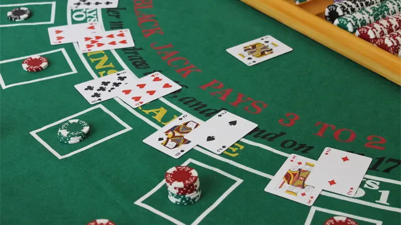 Calculator and smartphone displaying win loss percentage calculations for gambling bankroll management